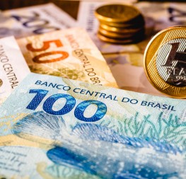In this photo illustration being displayed one hundred and two hundred reais bills and a one reais coin highlighted. The Real is the current money in Brazil.